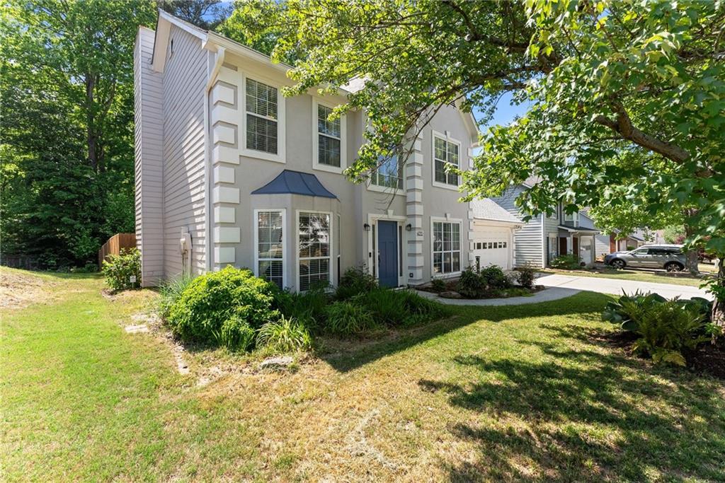 4055 Ivy Run Circle Duluth, GA 30096 - Photo 10 of 55 a view of a white house next to a yard with big trees