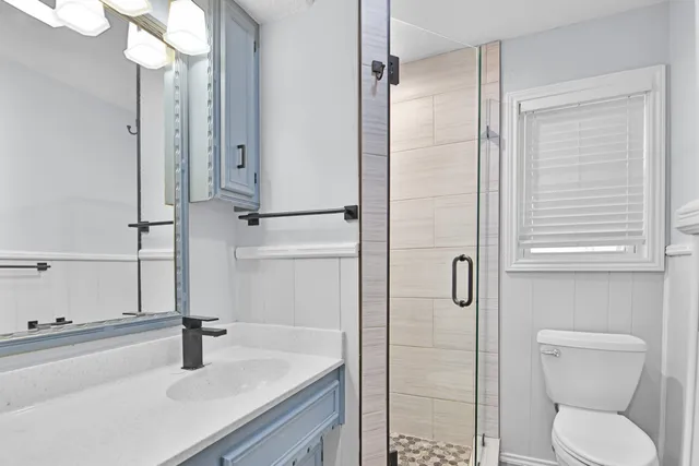 a bathroom with a sink toilet and shower