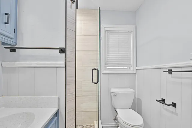 a bathroom with a toilet and a shower