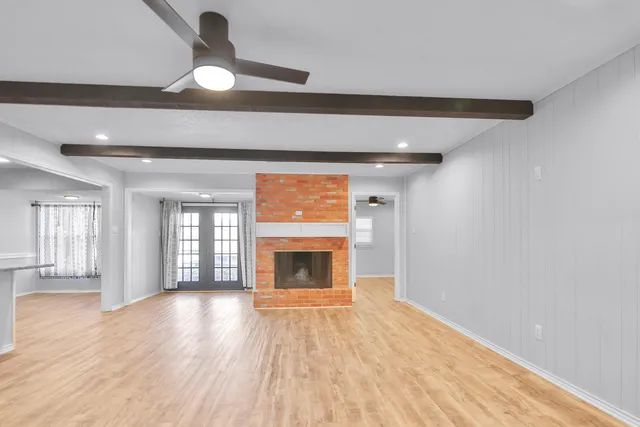 a view of an empty room and glass door