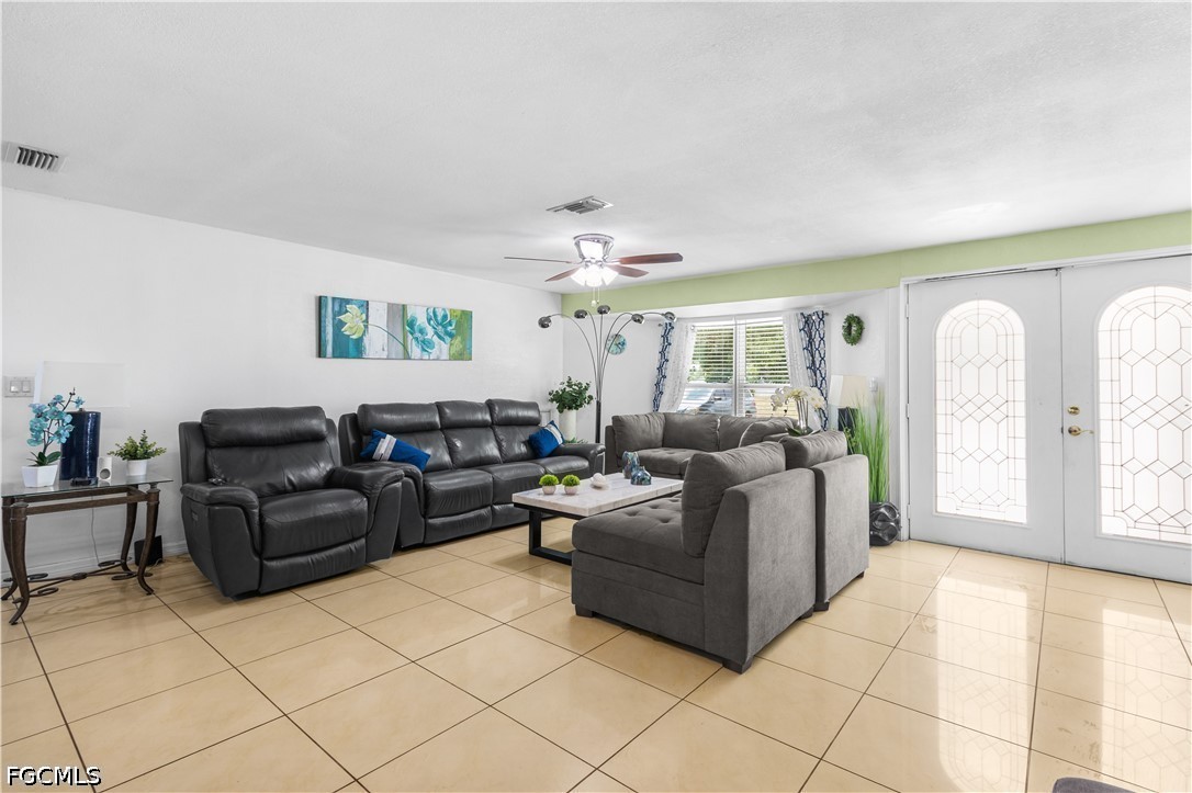 18 Illinois Road Lehigh Acres, FL 33936 - Photo 11 of 45 a living room with furniture and a chandelier