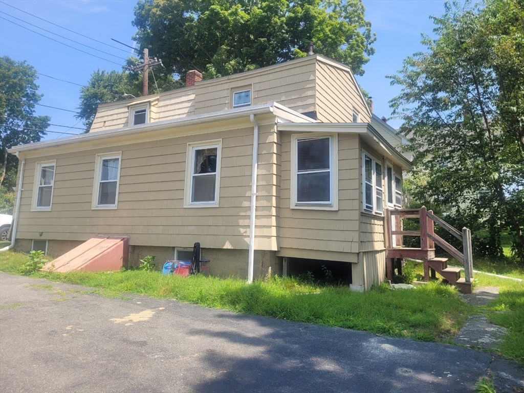 a front view of house with yard and green space