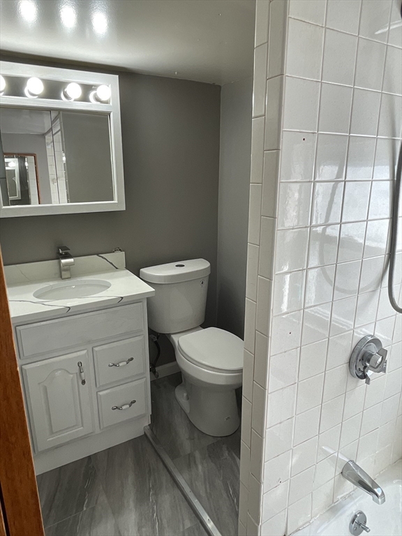 29 Jasper Street Saugus, MA 01906 - Photo 17 of 28 a bathroom with a toilet sink and mirror