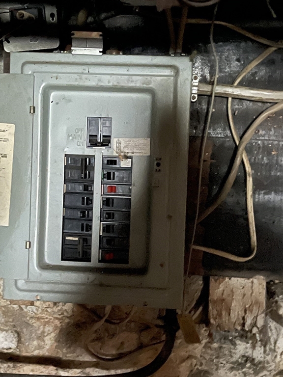 29 Jasper Street Saugus, MA 01906 - Photo 23 of 28 a room with water heater and a wooden floor