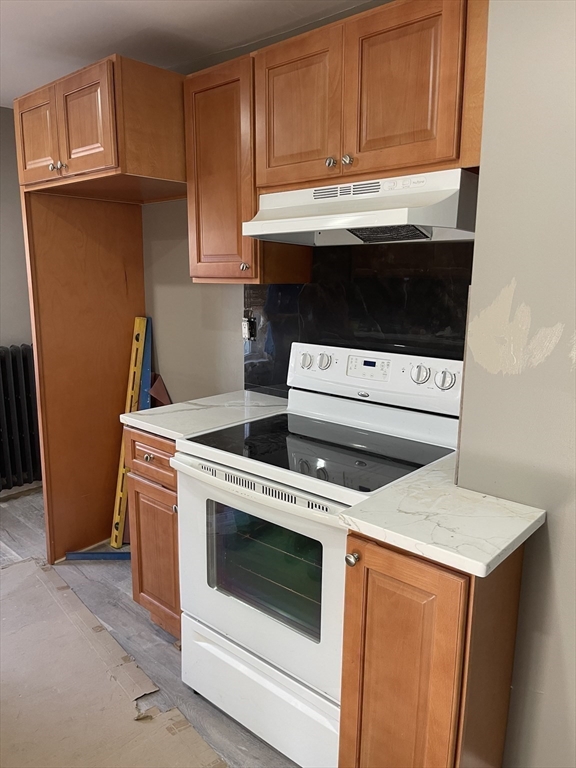 29 Jasper Street Saugus, MA 01906 - Photo 8 of 28 a kitchen with granite countertop white cabinets and white appliances