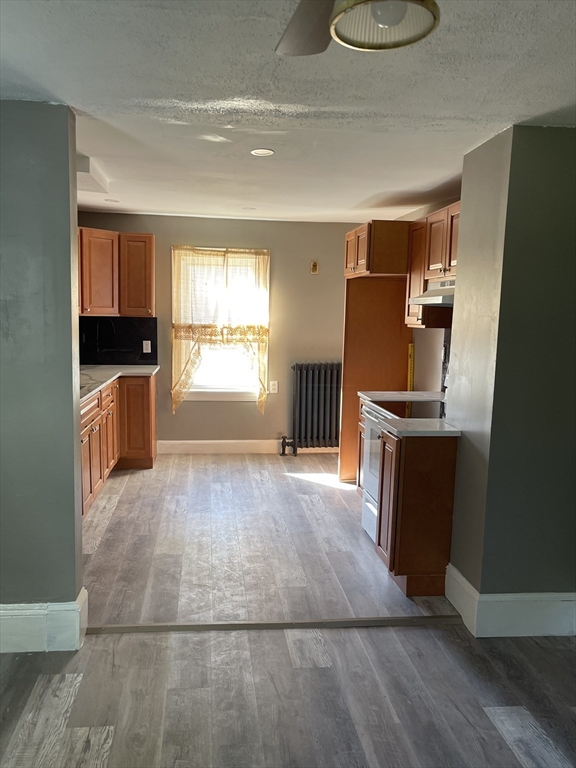 29 Jasper Street Saugus, MA 01906 - Photo 9 of 28 a kitchen with granite countertop a stove and a refrigerator