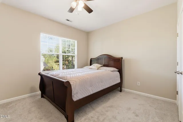 a bedroom with a bed and window