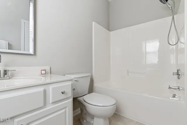 a bathroom with a sink toilet vanity and tub