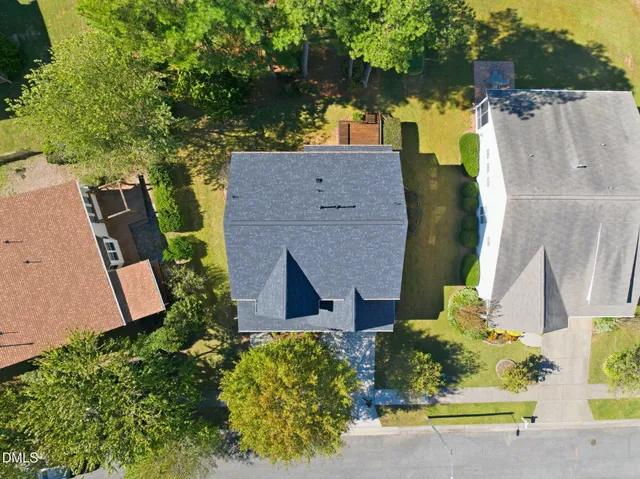an aerial view of a house with a garden and yard
