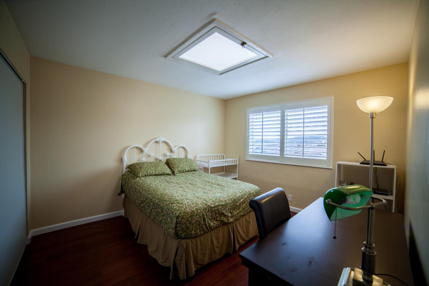 438 Firecrest Avenue Pacifica, CA 94044 - Photo 18 of 27 a bedroom with a bed and a table