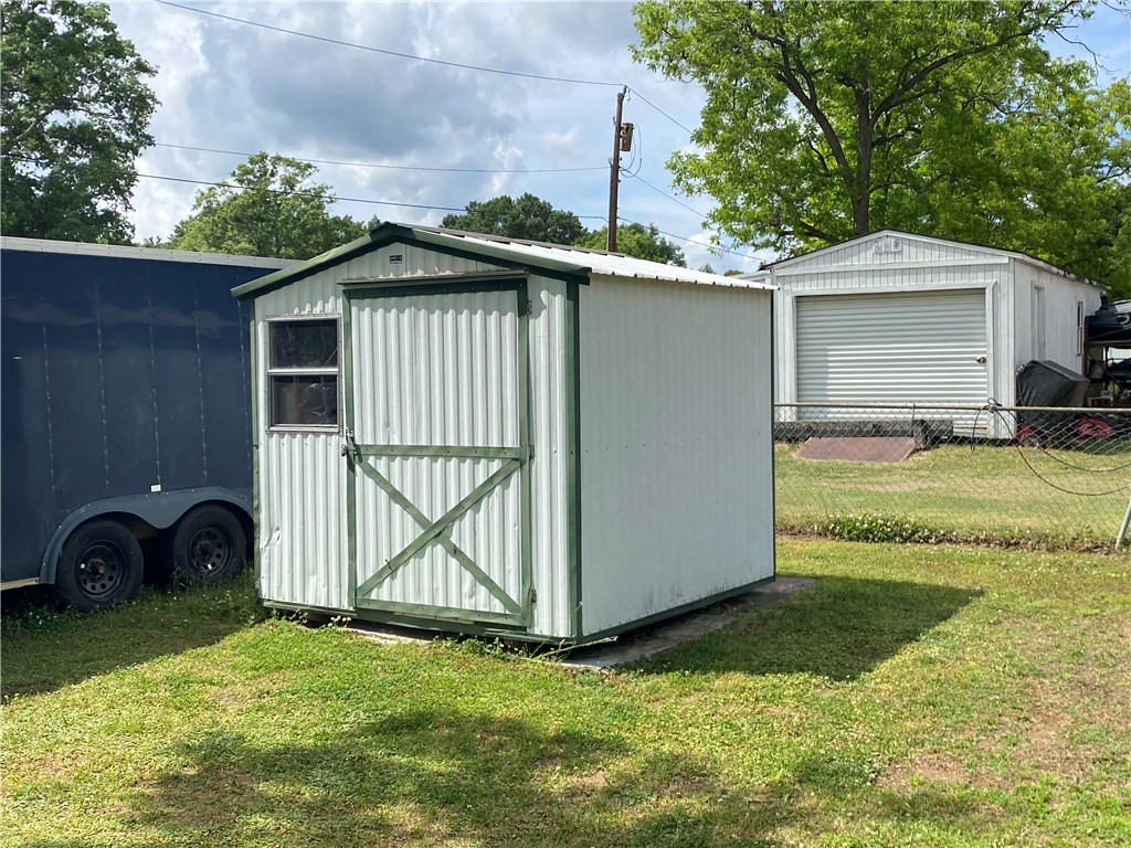 3 Heyward Avenue Honea Path, SC 29654 - Photo 27 of 35 This property offers practical storage solutions with a well-maintained shed and detached garage.