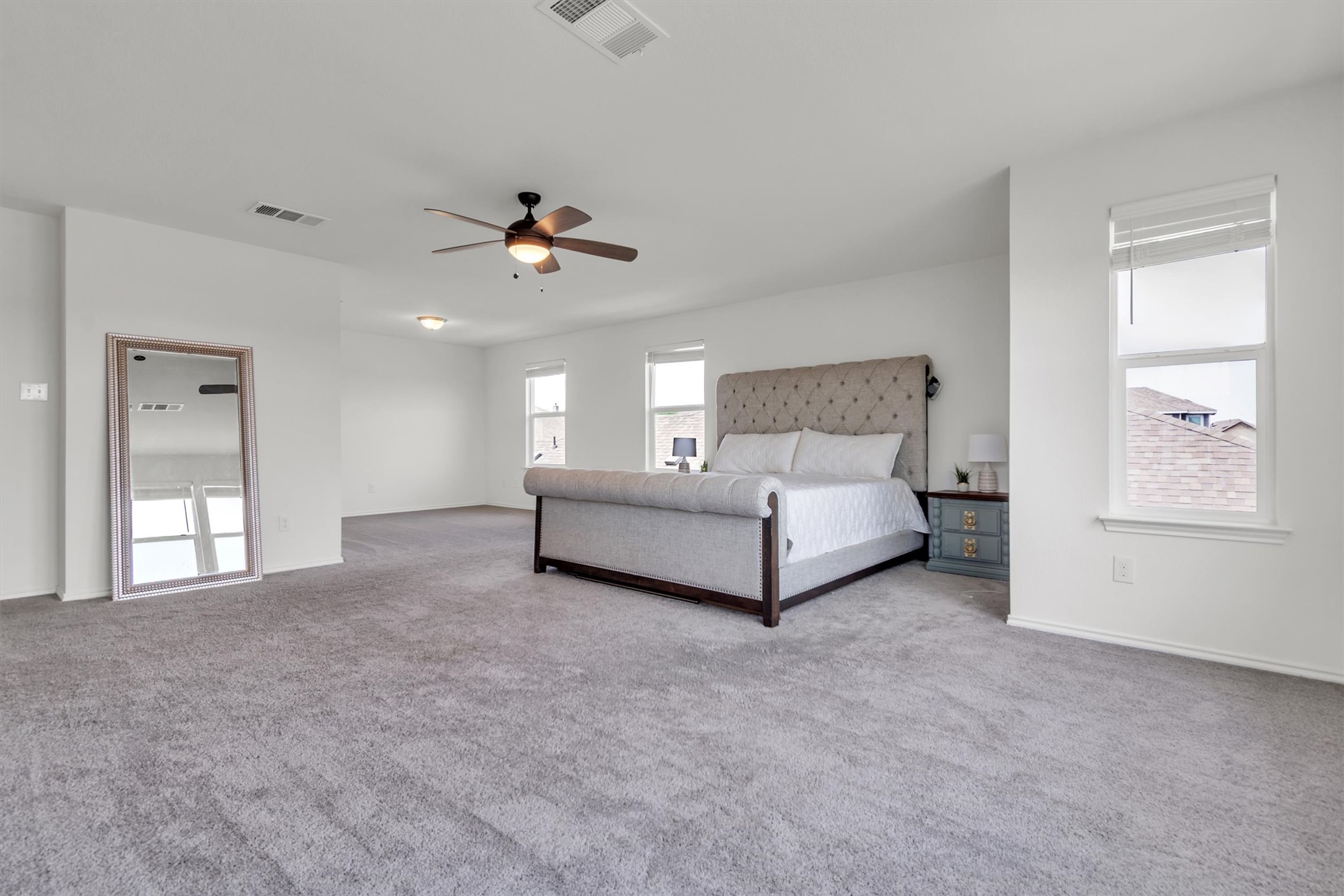 282 Crimson Lane Kyle, TX 78640 - Photo 12 of 18 Bedroom featuring light carpet and a ceiling fan