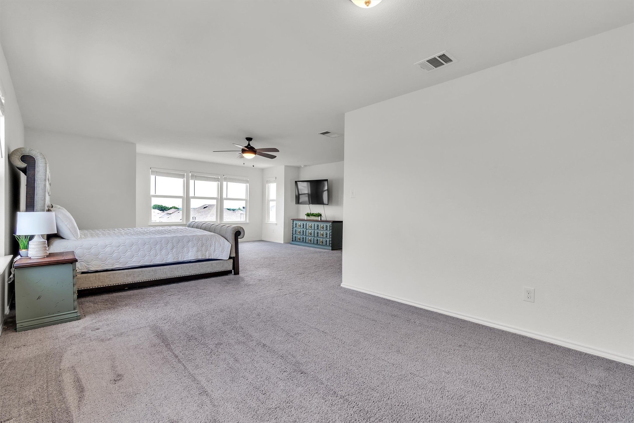 282 Crimson Lane Kyle, TX 78640 - Photo 13 of 18 Bedroom with light colored carpet and ceiling fan
