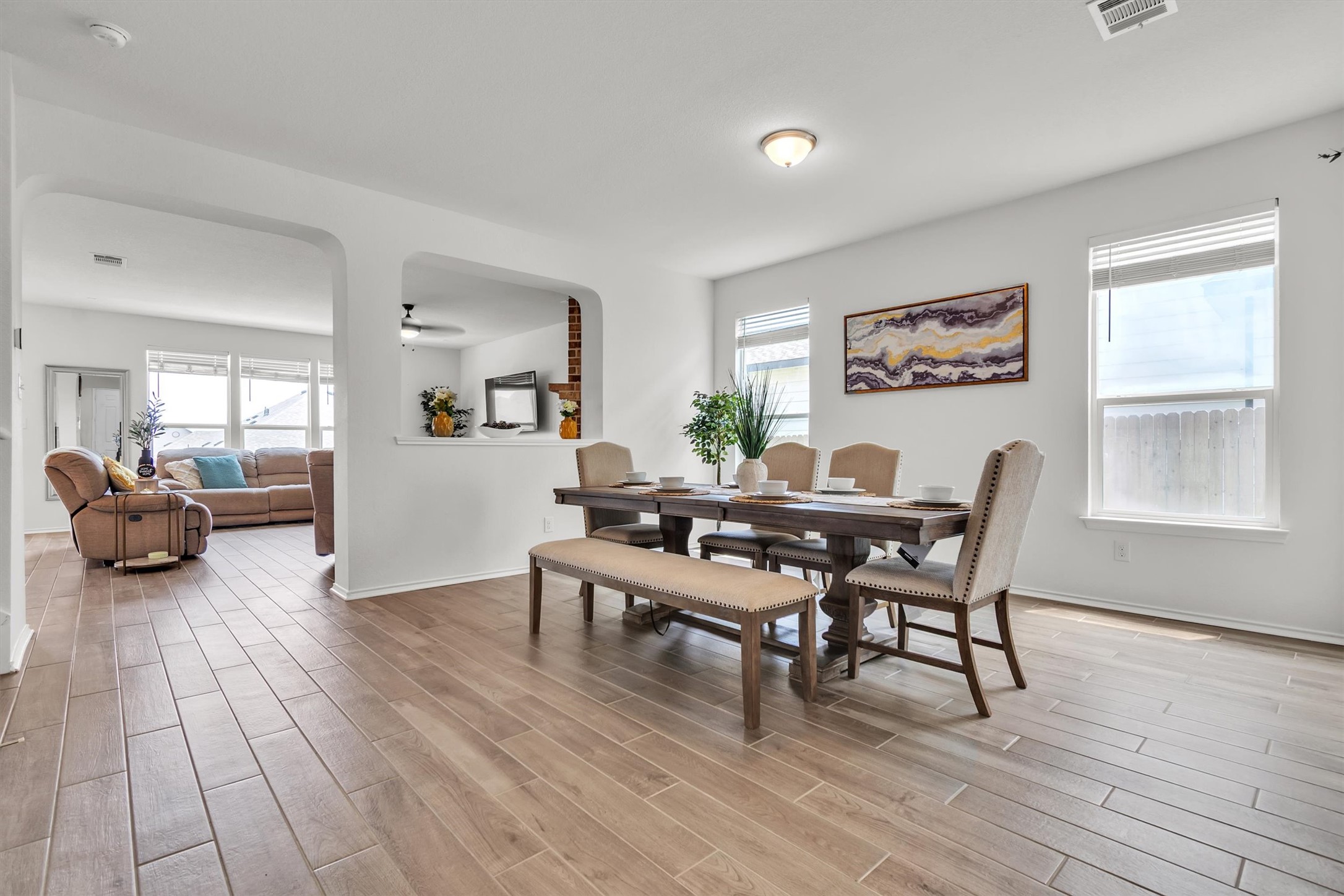 282 Crimson Lane Kyle, TX 78640 - Photo 2 of 18 Dining room with wood finish floors, plenty of natural light, arched walkways, and ceiling fan