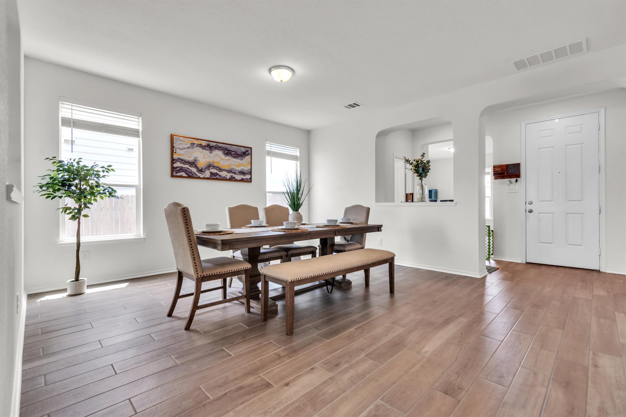 282 Crimson Lane Kyle, TX 78640 - Photo 3 of 18 Dining room with arched walkways and light wood finished floors