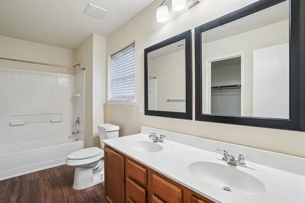 a bathroom with a toilet a sink and a large mirror