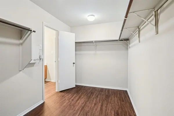 a view of walk in closet with empty racks