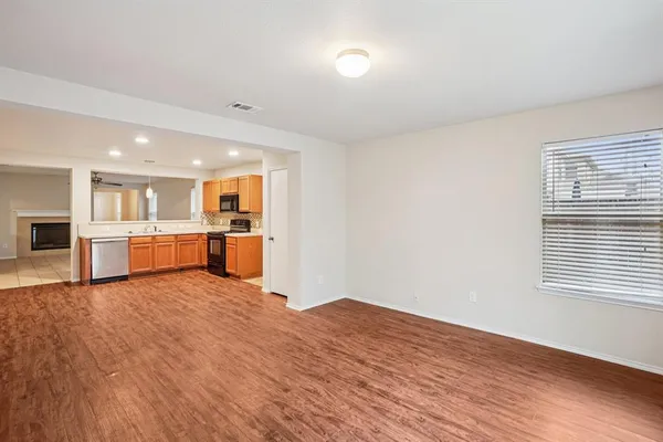 a view of kitchen with wooden floor and windows