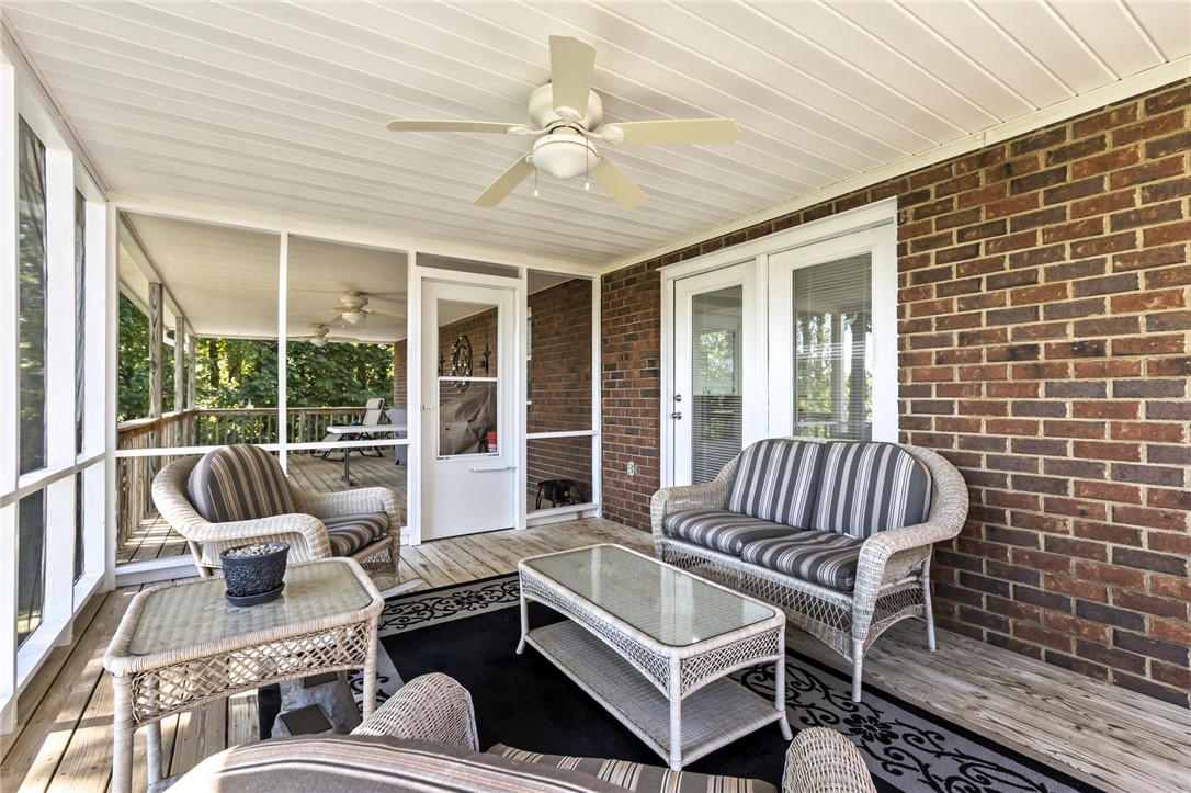 608 Robin Hood Lane Anderson, SC 29621 - Photo 26 of 36 A screened porch boasts classic brick accents and rustic wood flooring.
