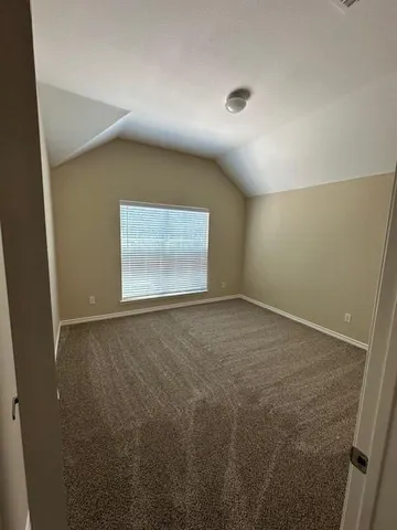 a front view of a house with a yard and potted plants