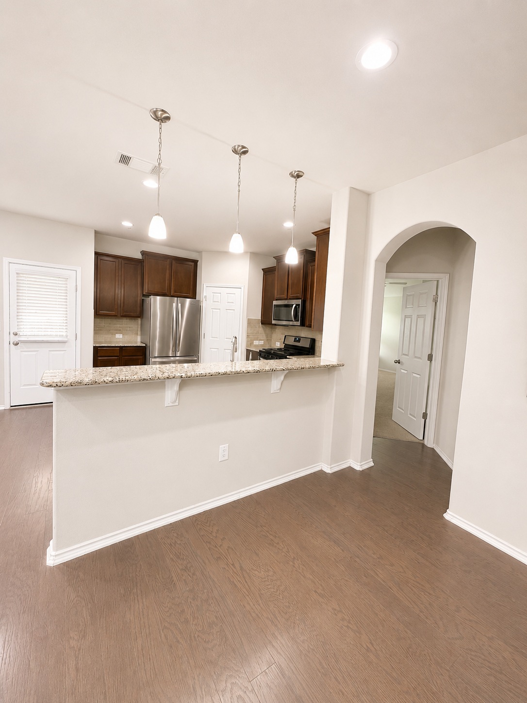 187 Limerick Road Buda, TX 78610 - Photo 4 of 18 A well-appointed kitchen featuring granite counters and pendant lighting over a breakfast bar.