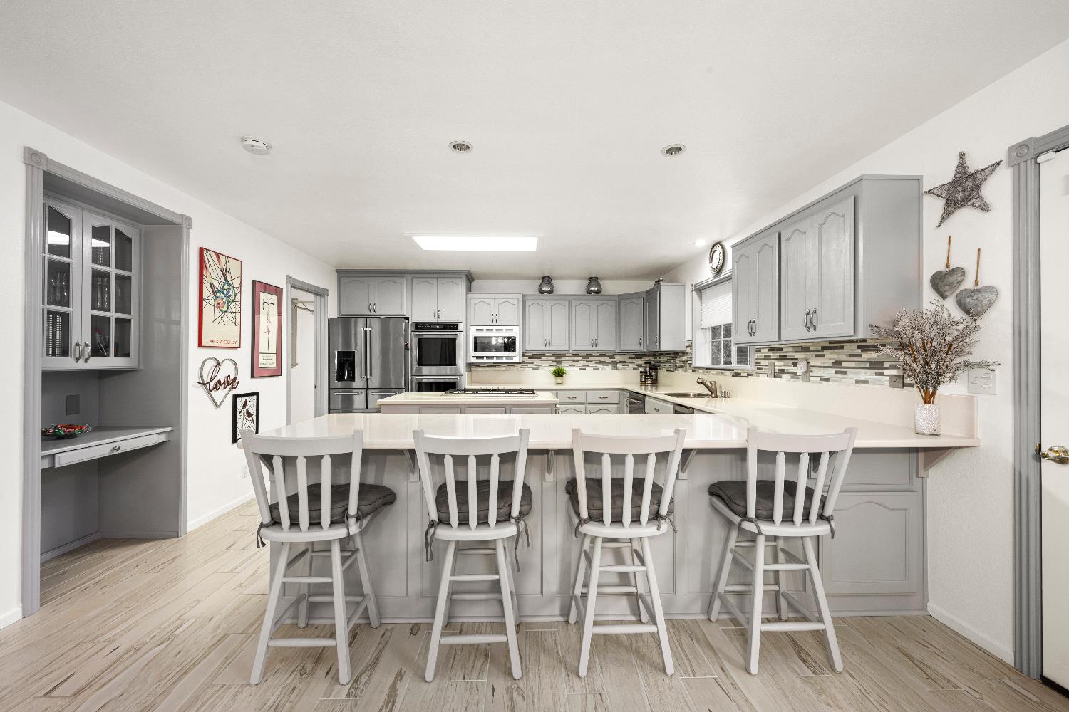 1049 Kimi Way Placerville, CA 95667 - Photo 11 of 66 a kitchen with stainless steel appliances kitchen island granite countertop a dining table chairs and sink