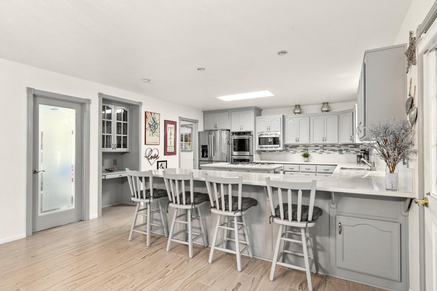 1049 Kimi Way Placerville, CA 95667 - Photo 19 of 66 a kitchen with stainless steel appliances kitchen island a table and chairs in it