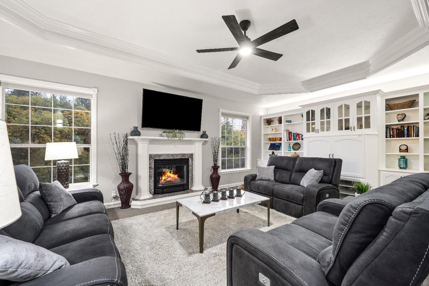 1049 Kimi Way Placerville, CA 95667 - Photo 21 of 66 a living room with furniture a fireplace and a flat screen tv