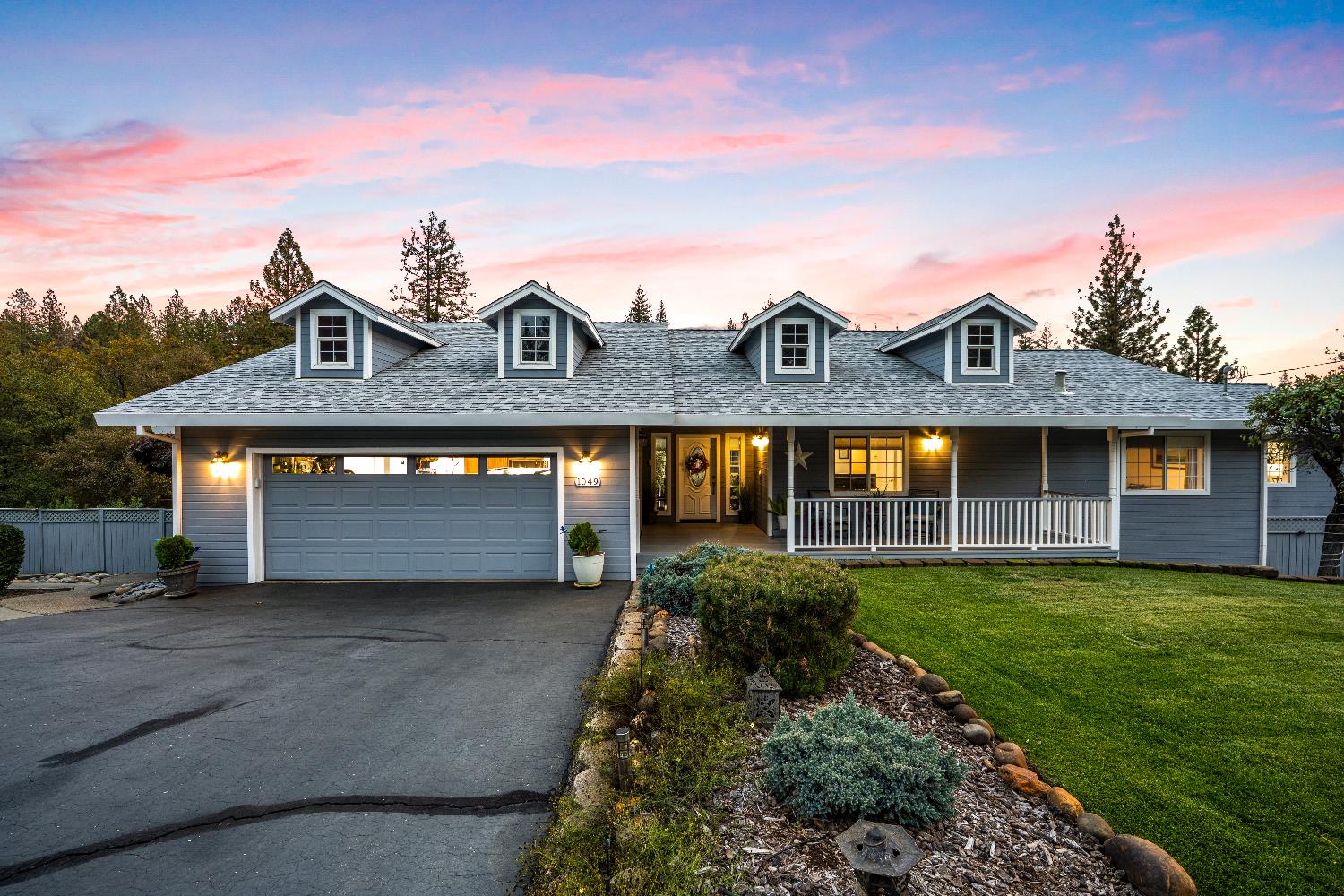 1049 Kimi Way Placerville, CA 95667 - Photo 3 of 66 a front view of a house with a yard and garage