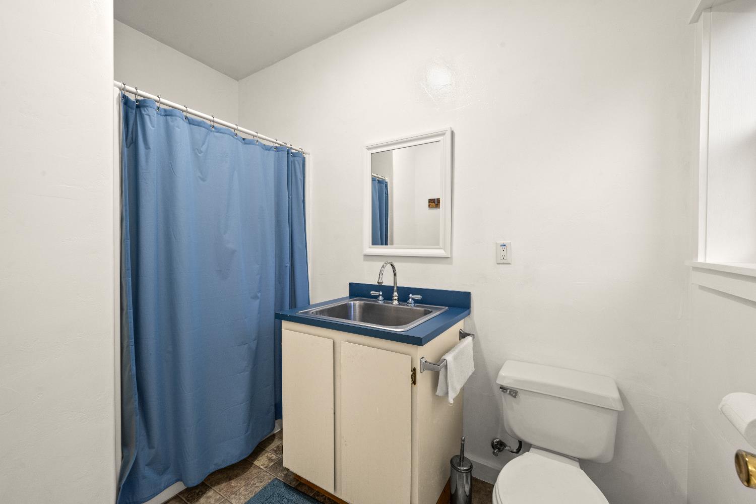 1049 Kimi Way Placerville, CA 95667 - Photo 44 of 66 a bathroom with a granite countertop toilet sink and mirror