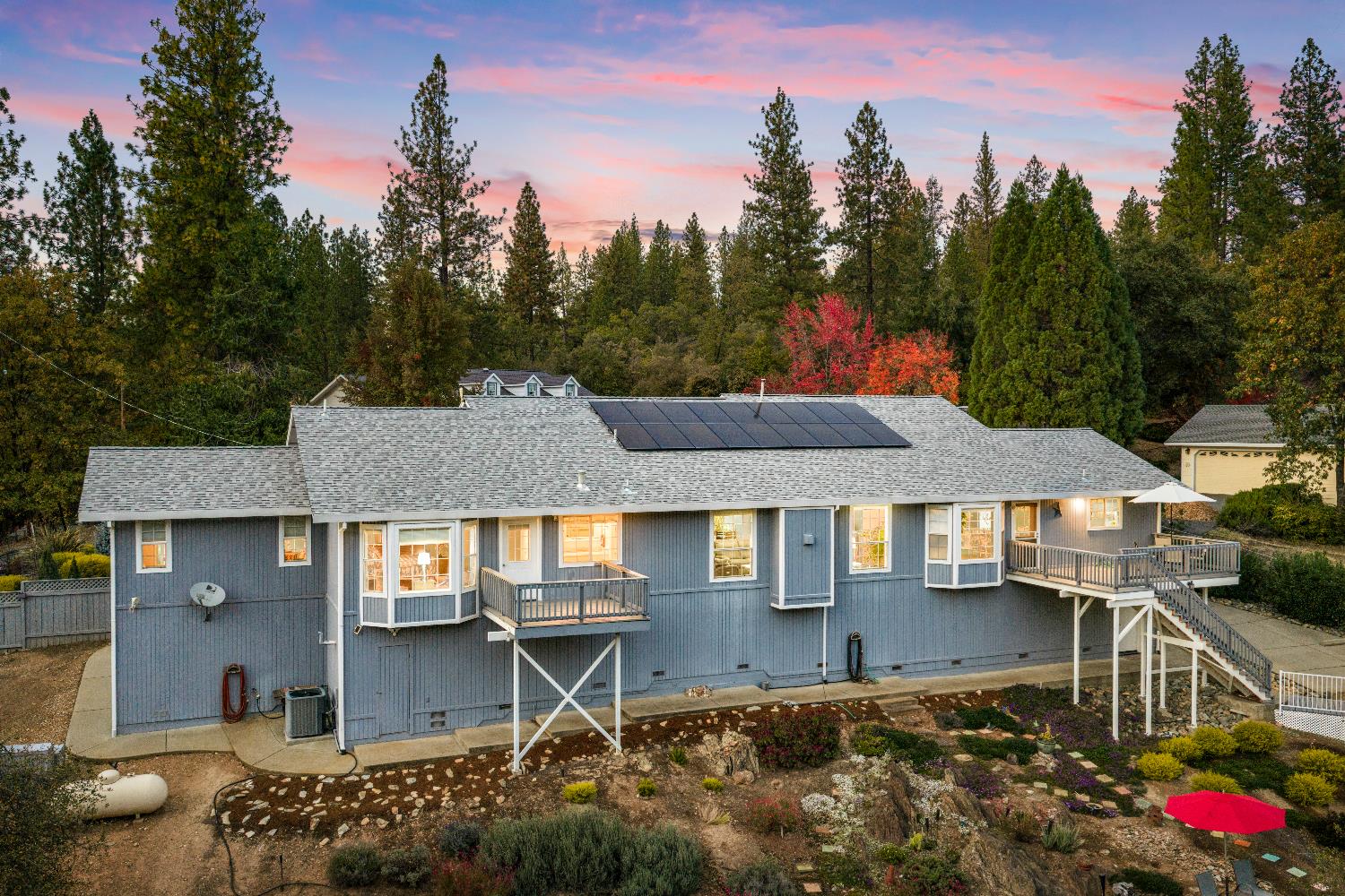1049 Kimi Way Placerville, CA 95667 - Photo 60 of 66 a aerial view of a house with table and chairs under an umbrella