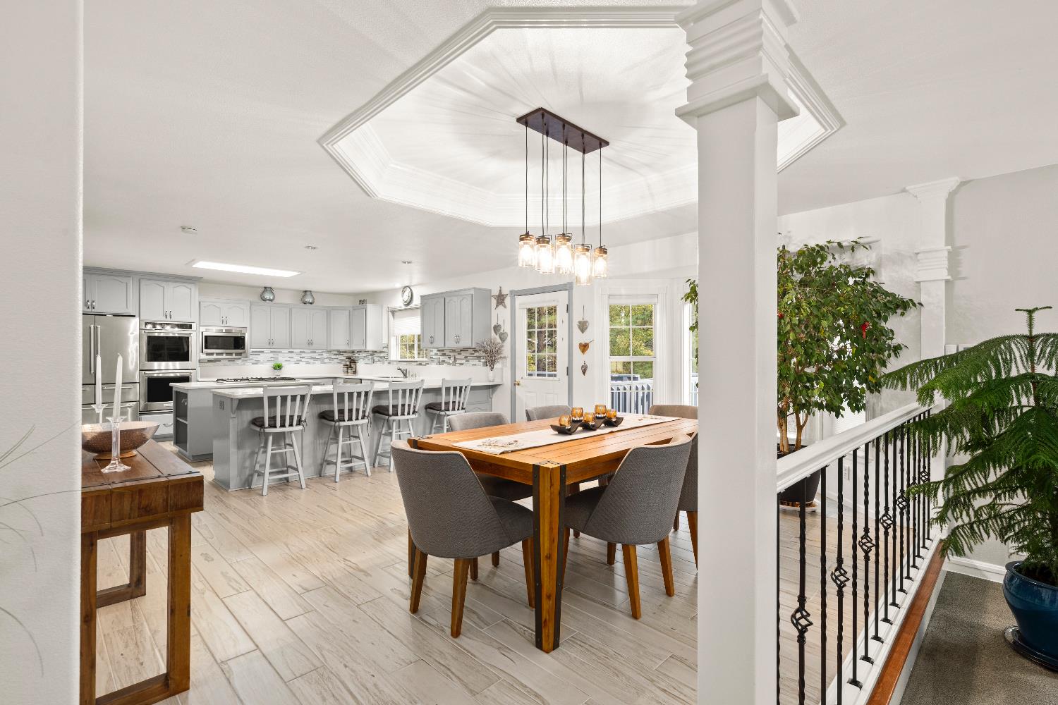 1049 Kimi Way Placerville, CA 95667 - Photo 6 of 66 a dining hall with stainless steel appliances kitchen island granite countertop a table chairs and a living room view