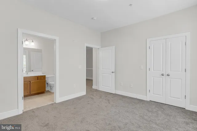 a view of an empty room and closet area