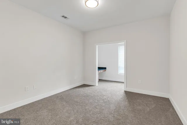 a view of an empty room and a window