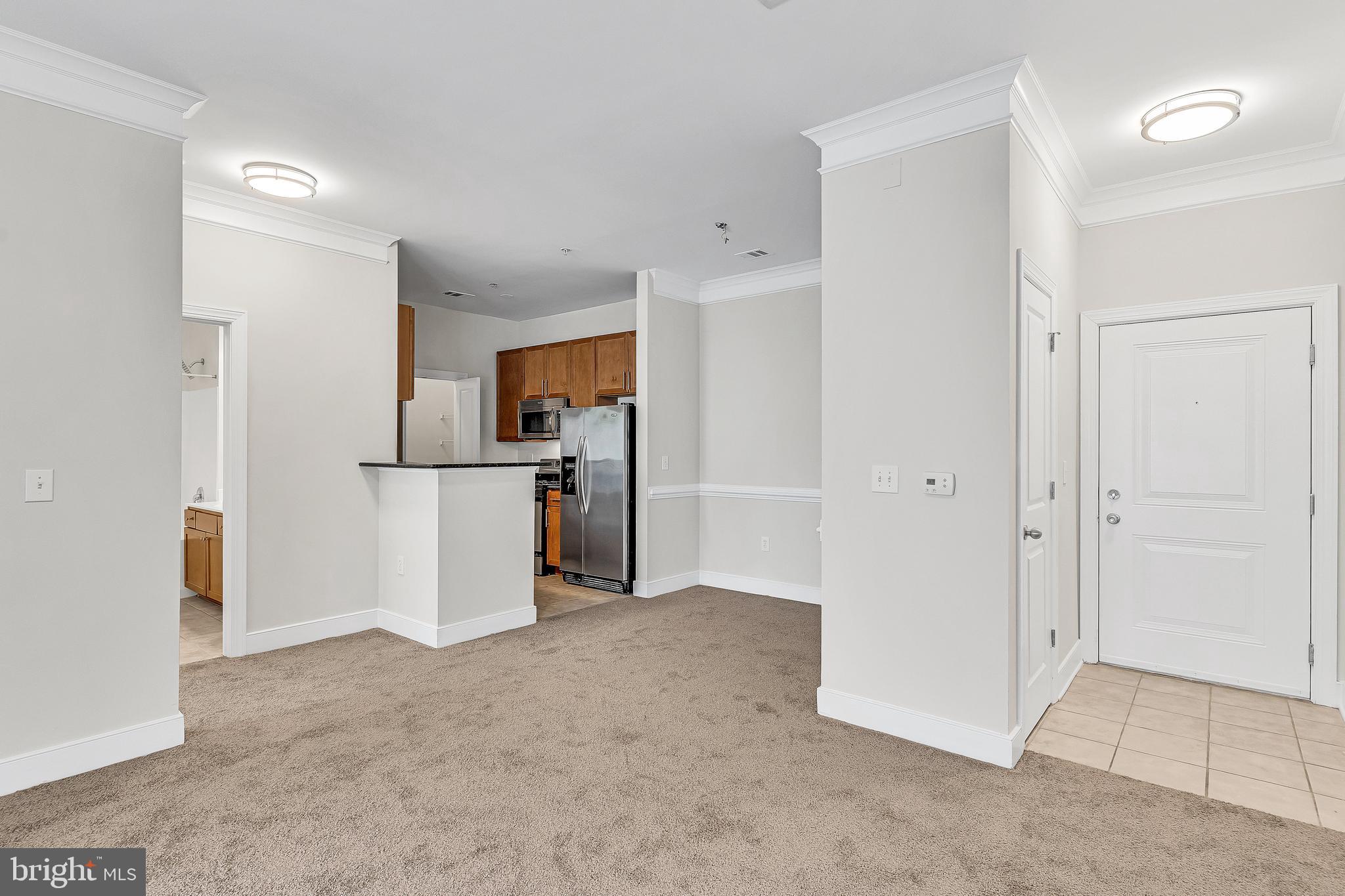 5400 Auth Road, Unit 337 Suitland, MD 20746 - Photo 3 of 37 wooden floor and an empty room with a kitchen
