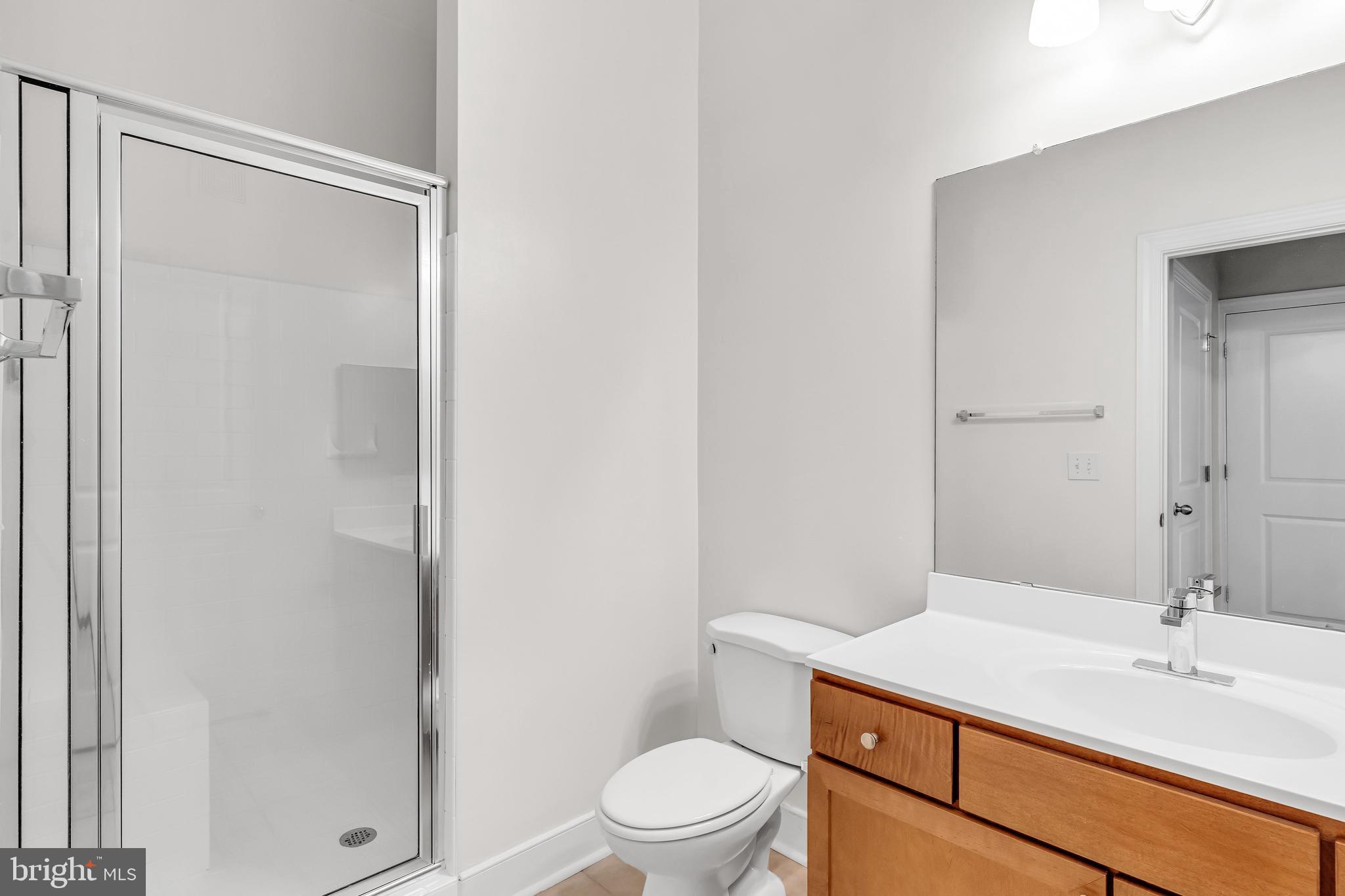 5400 Auth Road, Unit 337 Suitland, MD 20746 - Photo 31 of 37 a bathroom with a sink a toilet a shower and a mirror