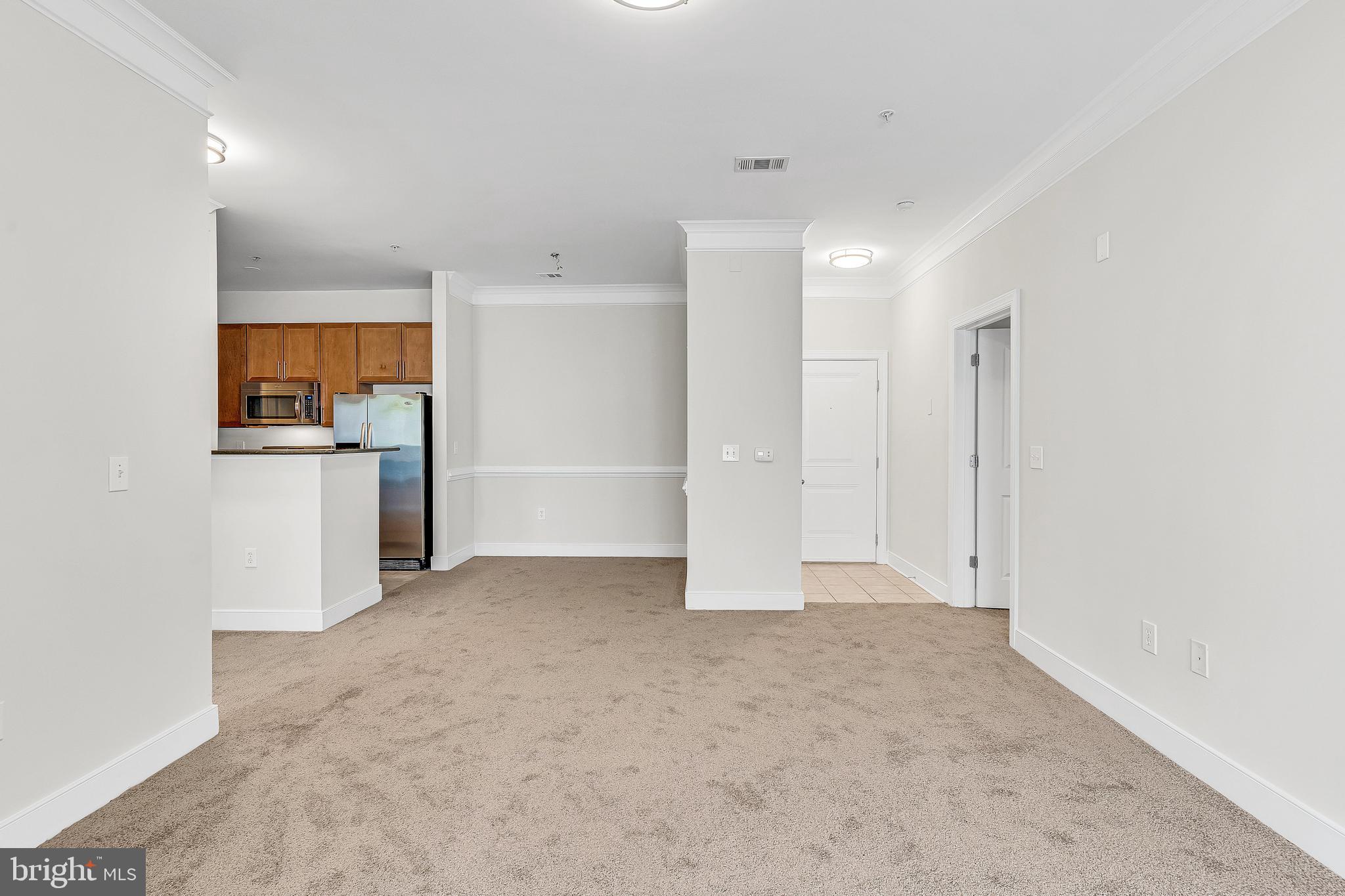 5400 Auth Road, Unit 337 Suitland, MD 20746 - Photo 4 of 37 a view of a kitchen with a refrigerator a stove top oven and cabinets