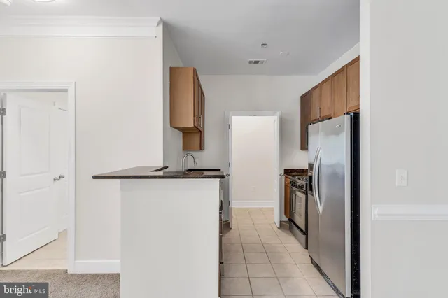 a kitchen with a refrigerator and a stove