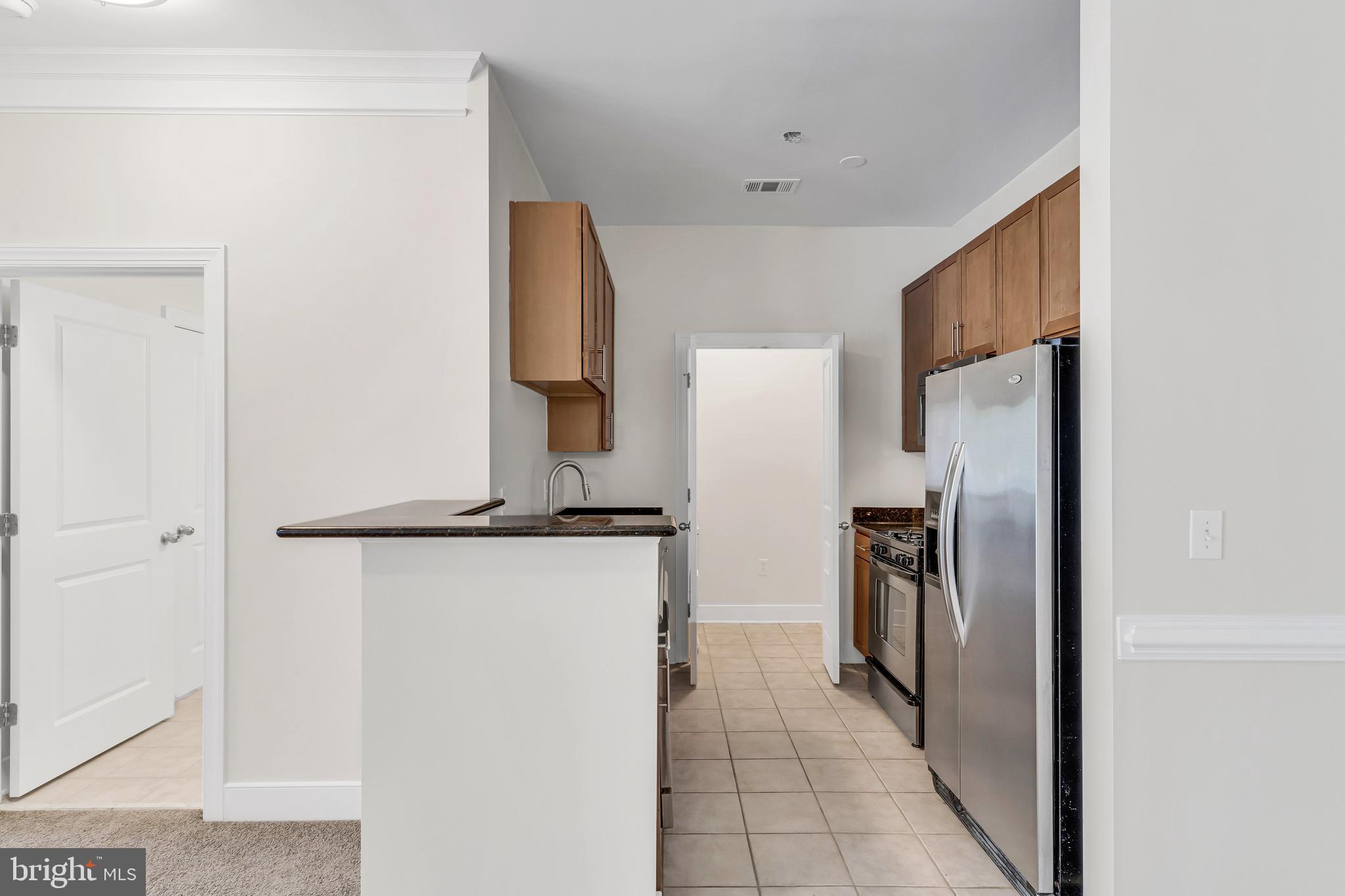 5400 Auth Road, Unit 337 Suitland, MD 20746 - Photo 6 of 37 a kitchen with a refrigerator and a stove