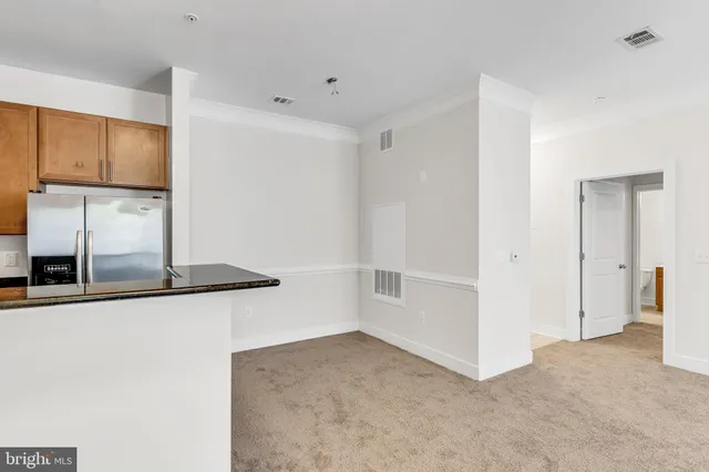 a view of a refrigerator a kitchen and a window
