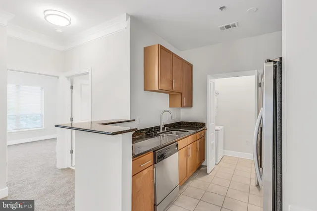 a kitchen with stainless steel appliances granite countertop a stove and a refrigerator