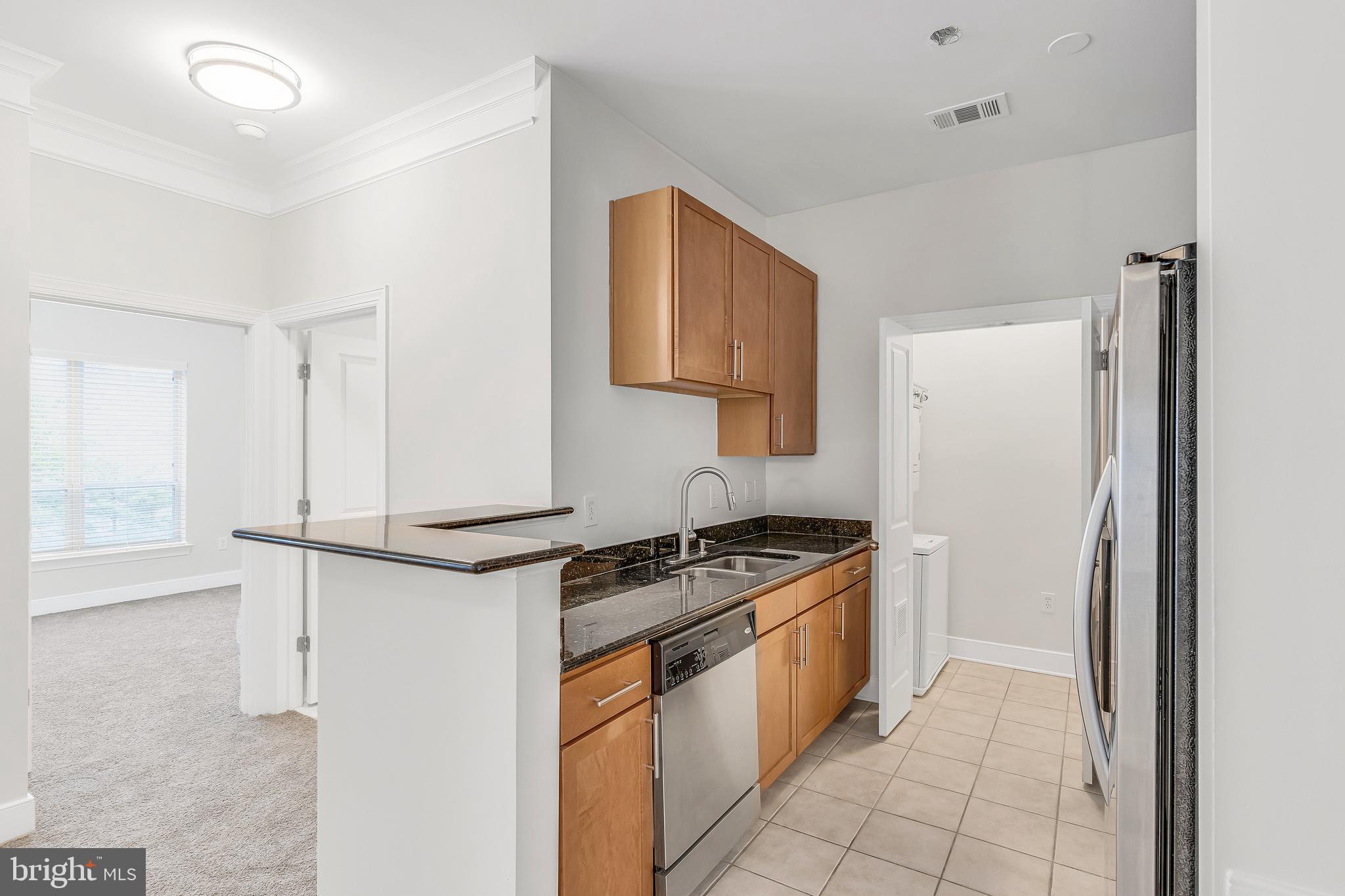 5400 Auth Road, Unit 337 Suitland, MD 20746 - Photo 8 of 37 a kitchen with stainless steel appliances granite countertop a stove and a refrigerator
