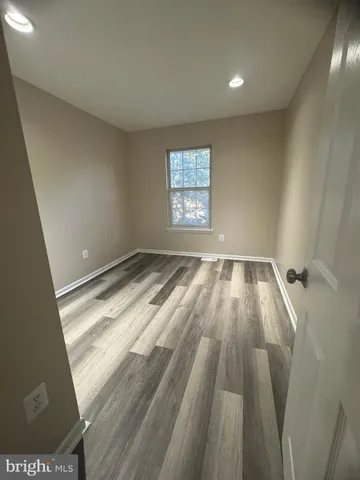 a view of wooden floor and windows in a room