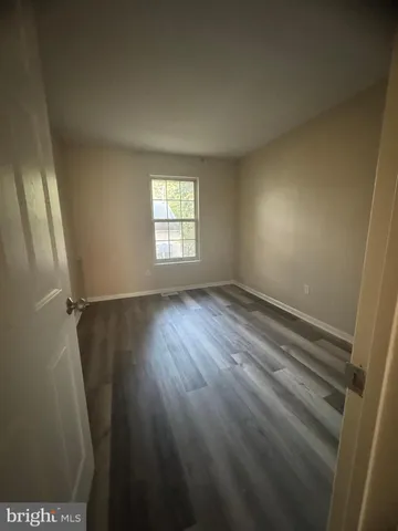 a view of room with window and hardwood floor