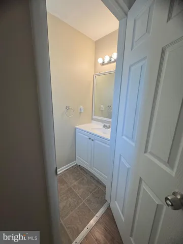a bathroom with a sink and mirror with toilet