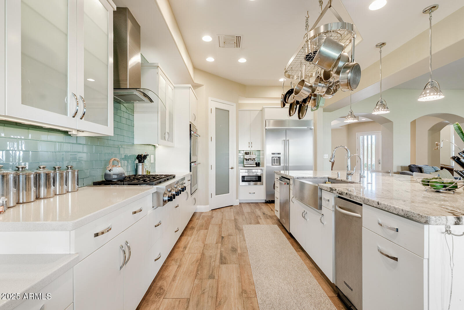 8705 South 24th Place Phoenix, AZ 85042 - Photo 16 of 43 a large kitchen with stainless steel appliances lots of counter space and wooden floor