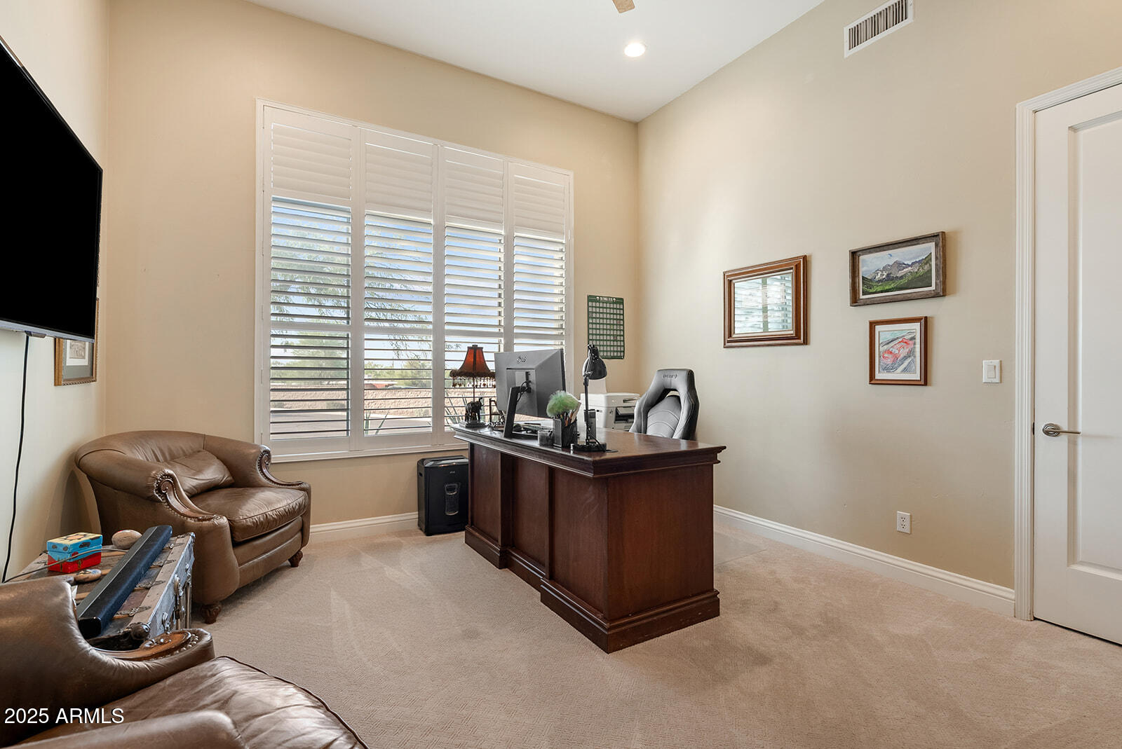 8705 South 24th Place Phoenix, AZ 85042 - Photo 27 of 43 a living room with furniture a flat screen tv and a window