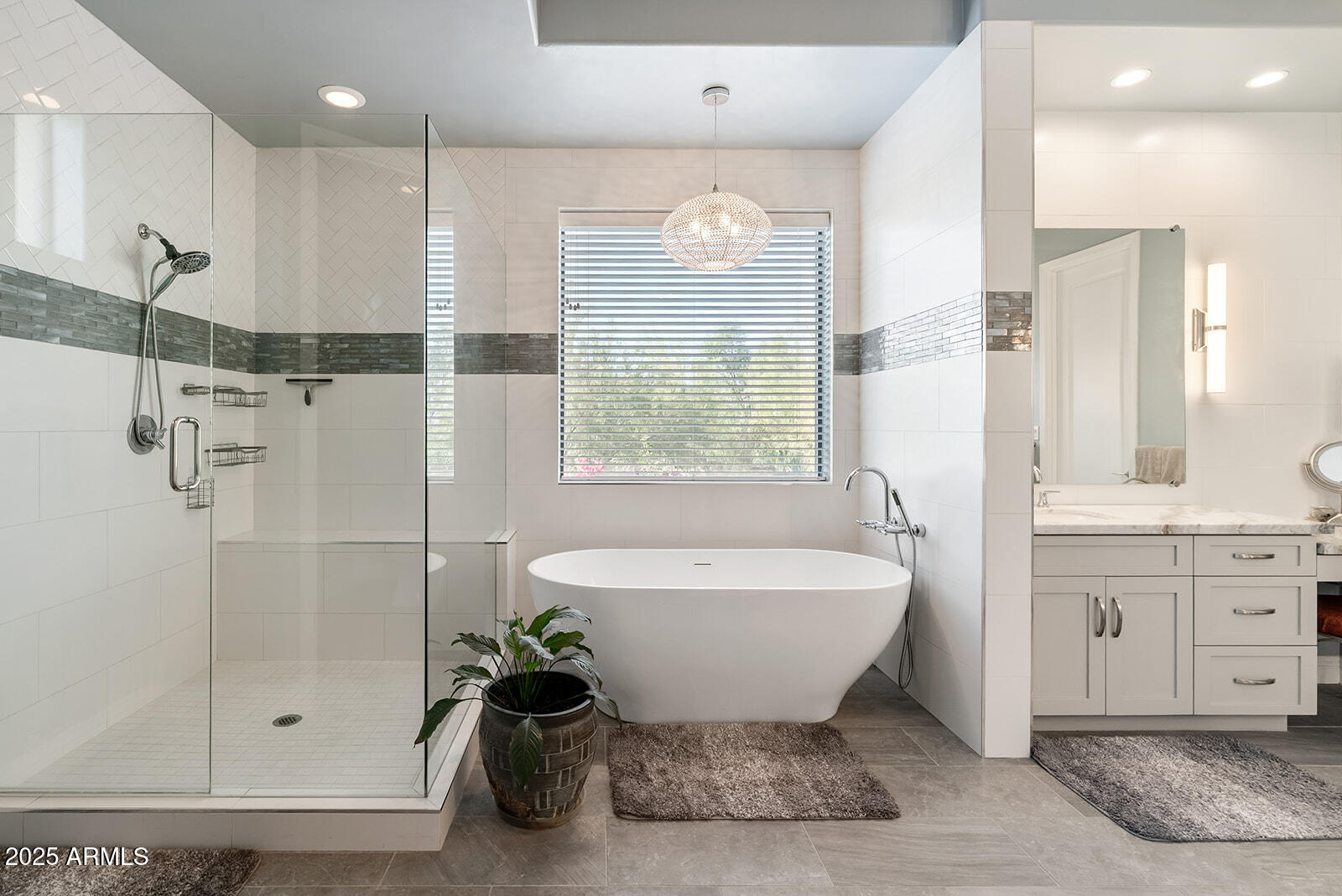 8705 South 24th Place Phoenix, AZ 85042 - Photo 30 of 43 a spacious bathroom with a shower sink and mirror