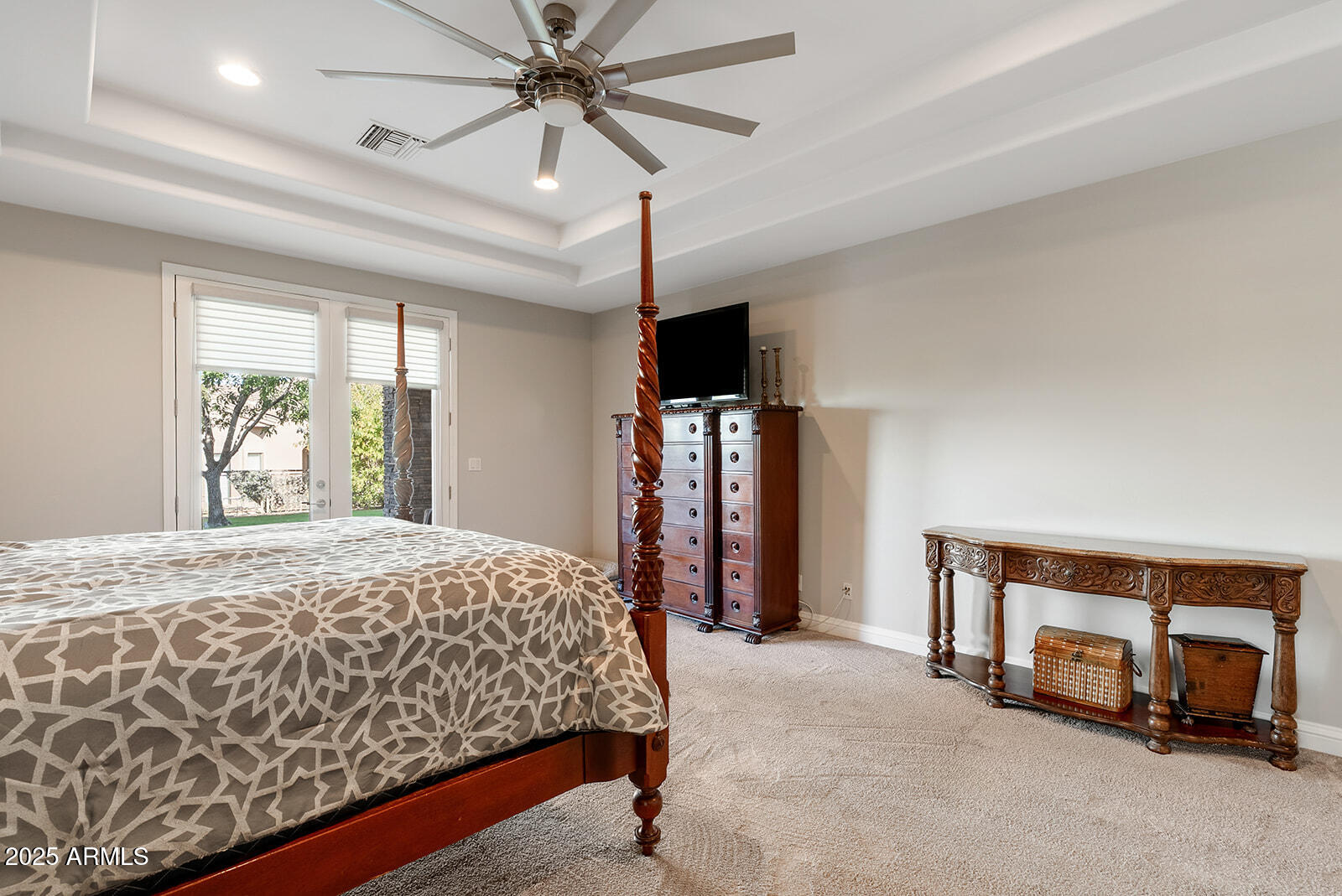 8705 South 24th Place Phoenix, AZ 85042 - Photo 34 of 43 a bedroom with a bed and a chandelier