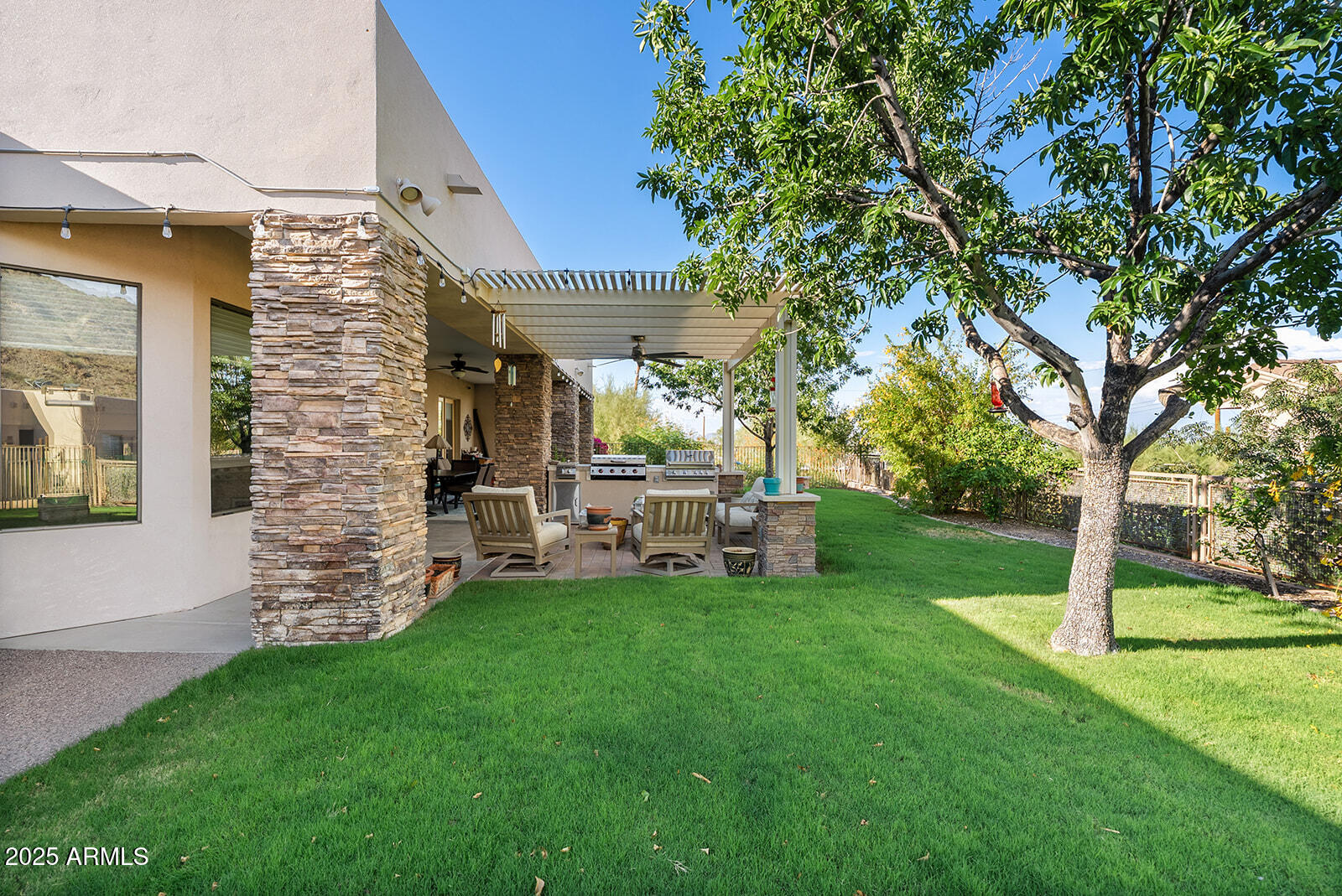 8705 South 24th Place Phoenix, AZ 85042 - Photo 36 of 43 a view of a chair and table in backyard of the house